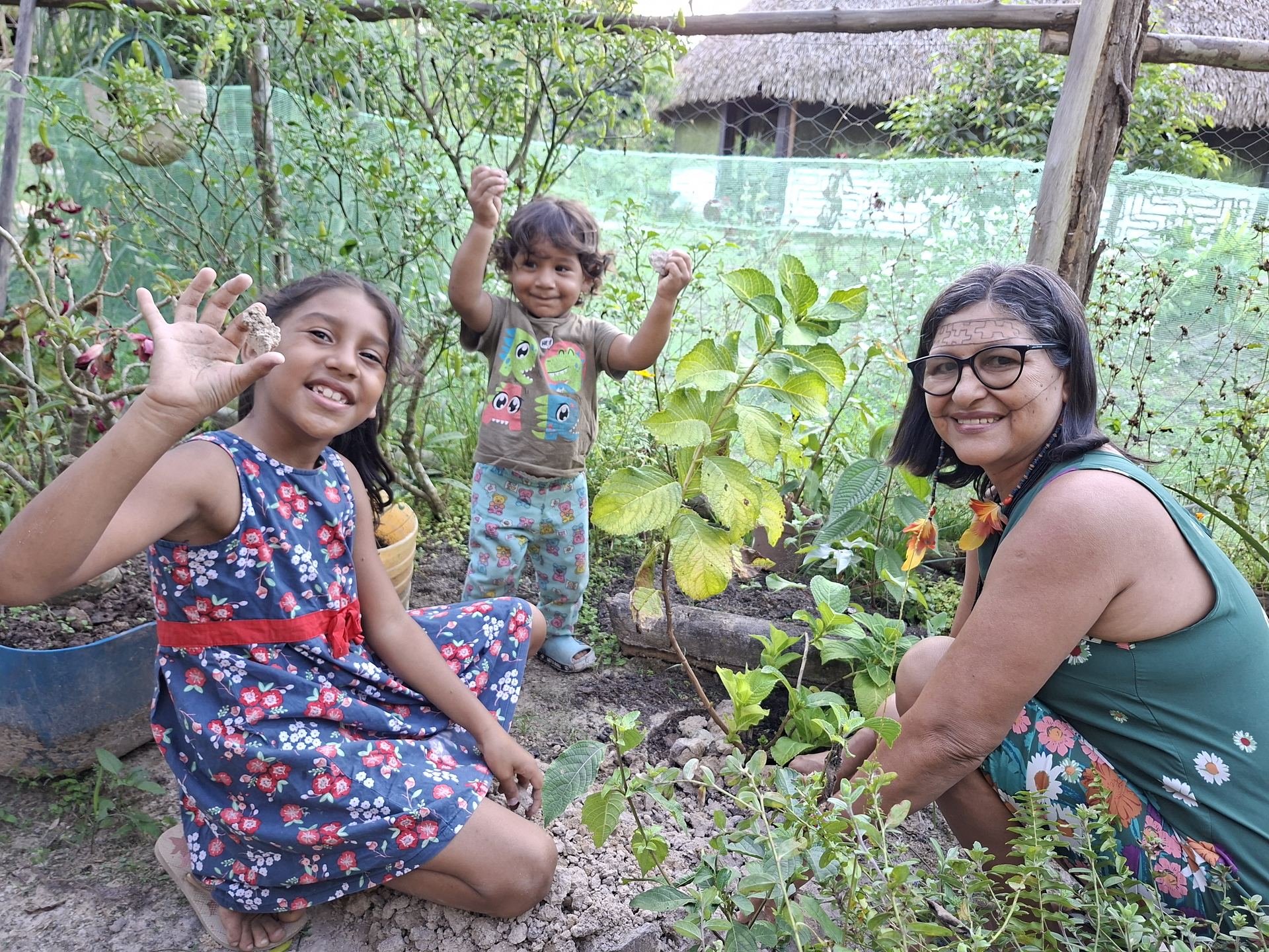 Planting a tree seedling in a community medicinal garden